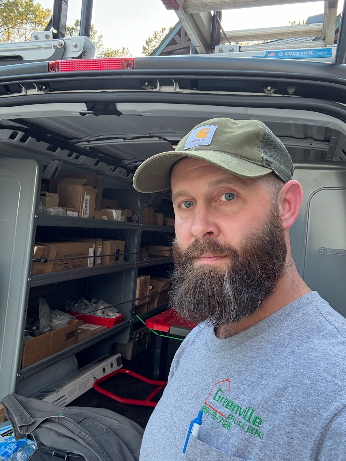 Blake Miller, owner of Greenville Appliance Repair, standing in front of his fully-stocked service van