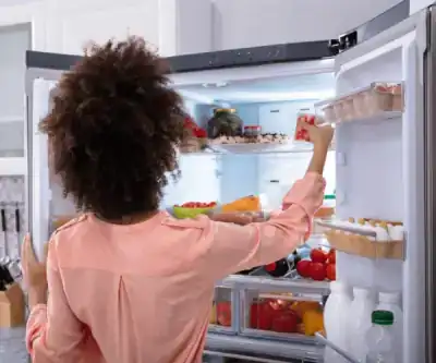 Blake Miller diagnosing a refrigerator in a customer's kitchen